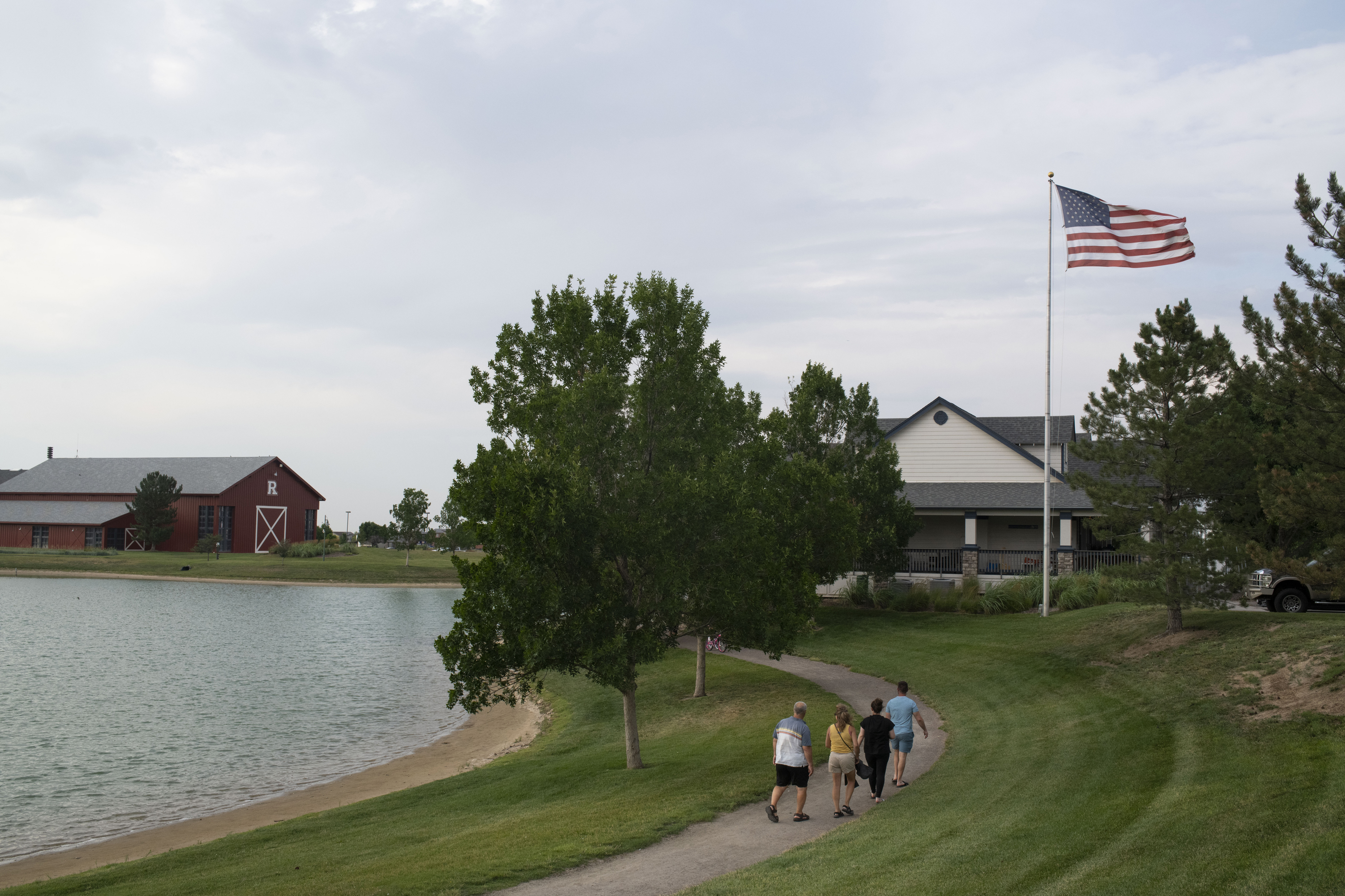 People walk in the Reunion community in Commerce City, Colo., on July 16. MUST CREDIT: photo for The Washington Post by Rachel Woolf.