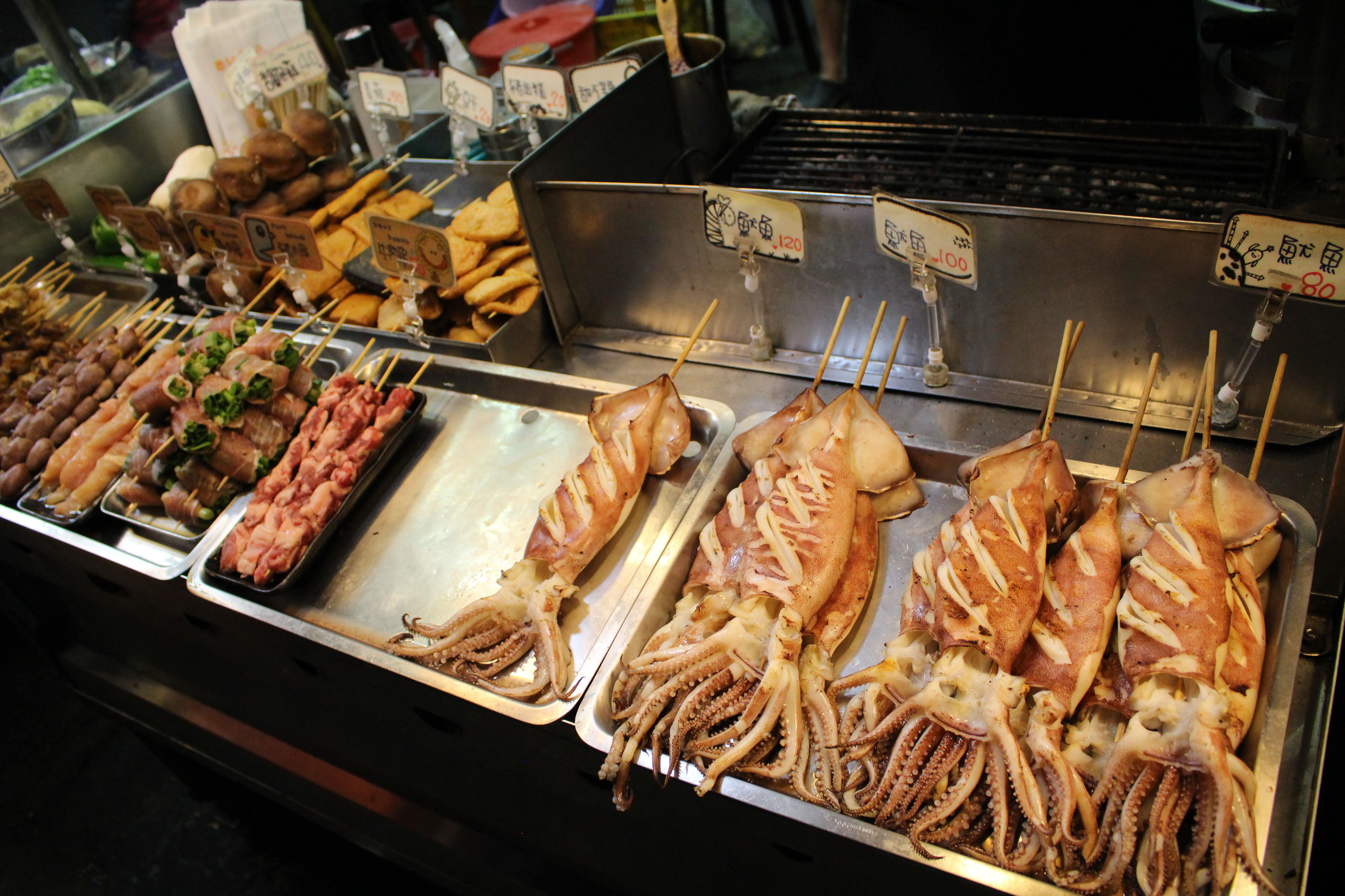 Skewers of grilled squid are on display at the Shilin Night Market. Must credit: Washington Post photo by Katherine Lee