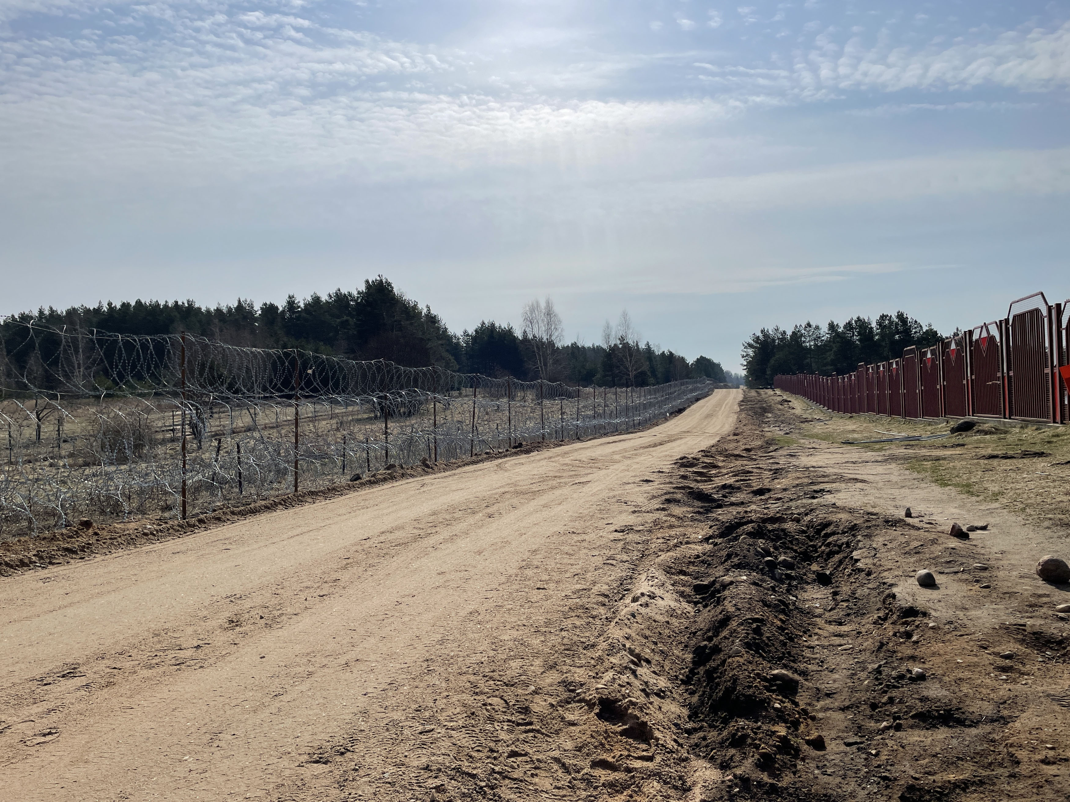 Polish security officials strung razor wire to stop immigrants crossing from Belarus and are now working on a more permanent steel wall. MUST CREDIT: Washington Post photo by Chico Harlan.
